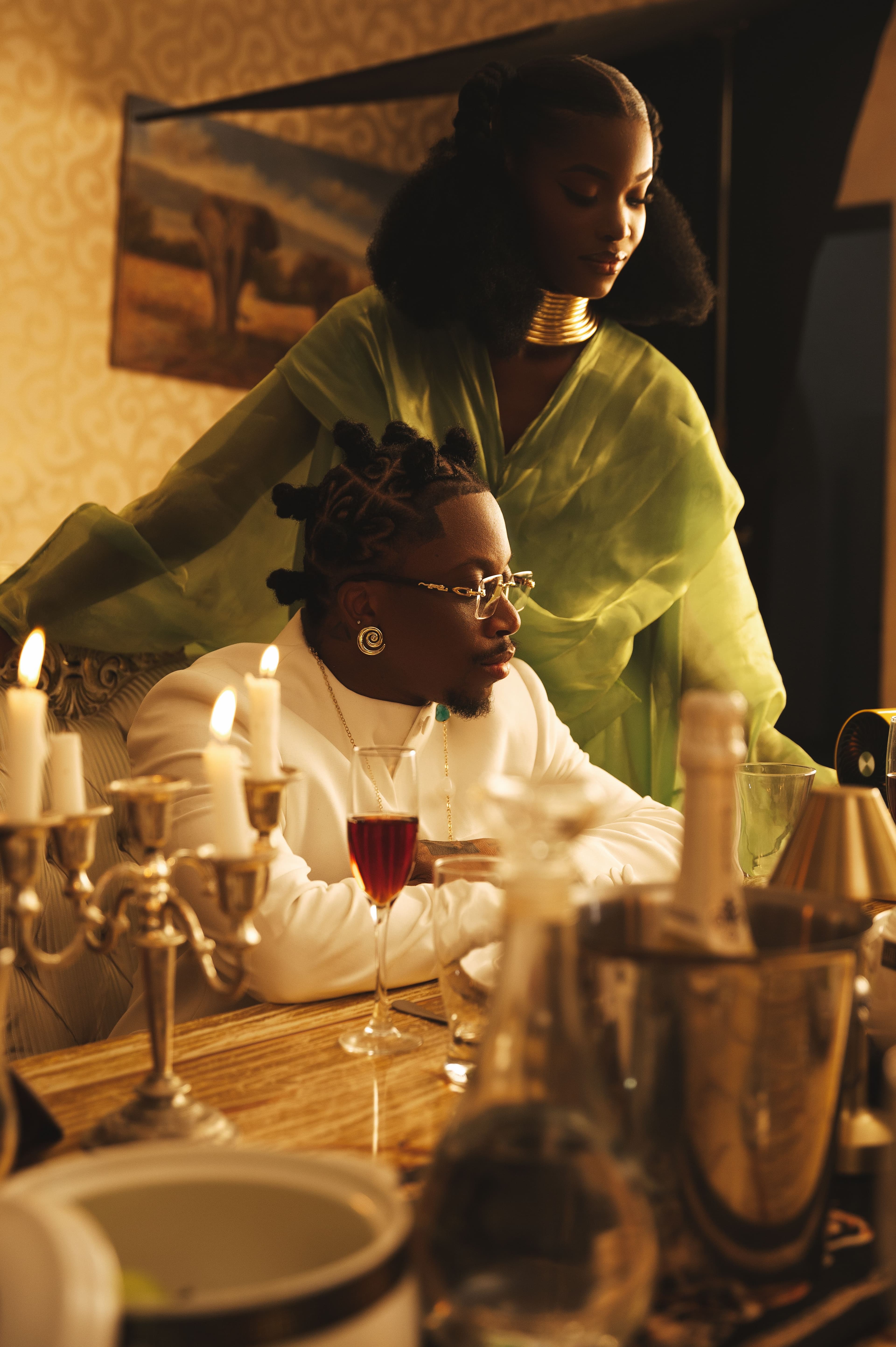 A candlelit dinner table set with wine, shared in the evening.