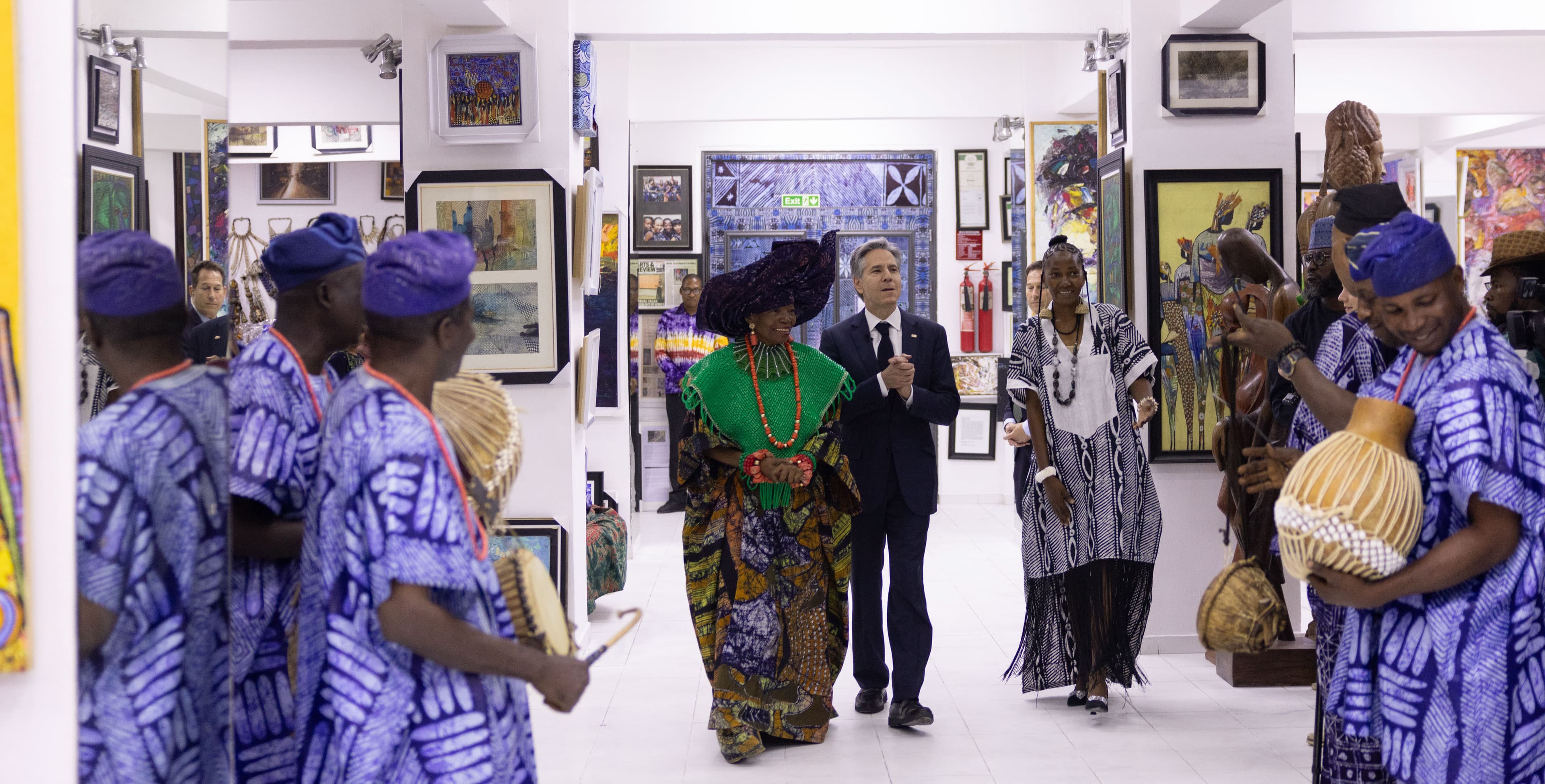 Visitors touring the gallery halls at Nike Art Gallery, art covering every wall.