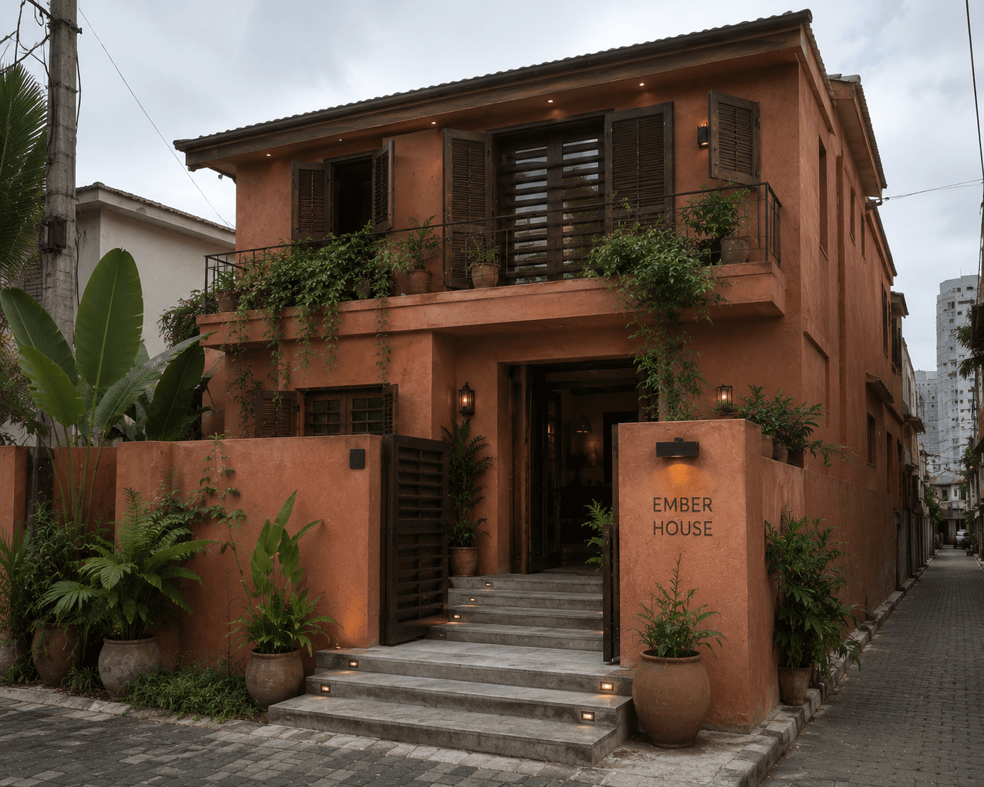 The clay-toned street entrance to Ember House on Lagos Island.